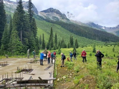 People are standing in a clearing.