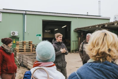 One person gives advice in a greenhouse