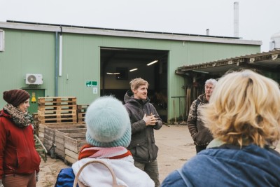 One person gives advice in a greenhouse