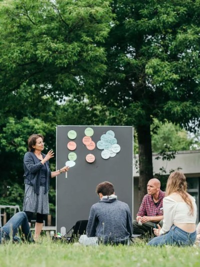 A woman is explaining something on a diagram