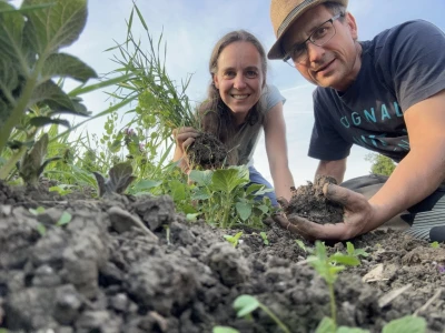 Two people digging in the ground