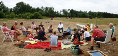 People sitting in a circle on a field
