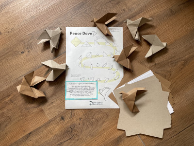 Origami doves and the instructions are on the floor