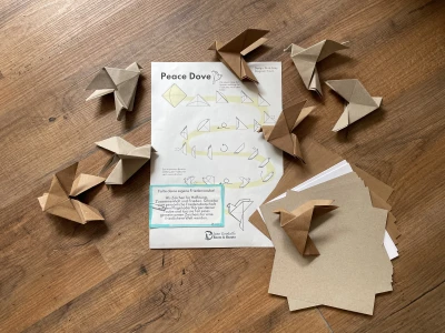 Origami doves and the instructions are on the floor