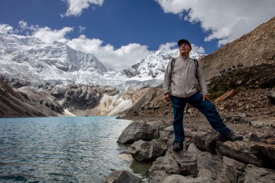 A man near a mountain lake